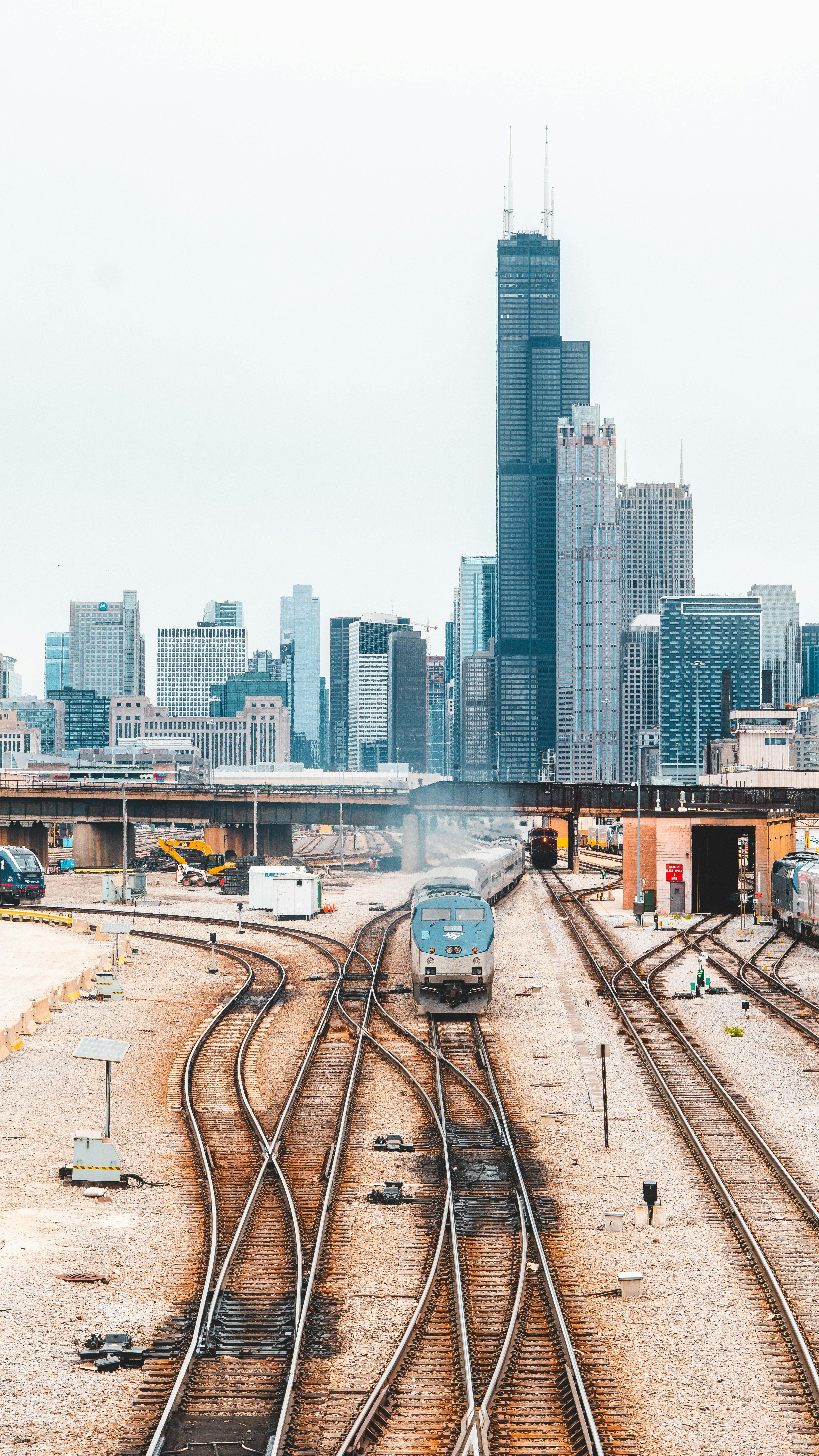 brown and black train railway near high buildings