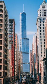 Skyline view of Chicago's Trump Tower with downtown architecture and a passing train.