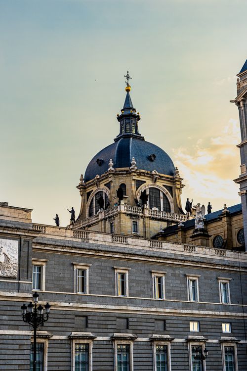 Free Captivating view of Almudena Cathedral's dome under a vibrant sunset sky, showcasing architectural elegance. Stock Photo