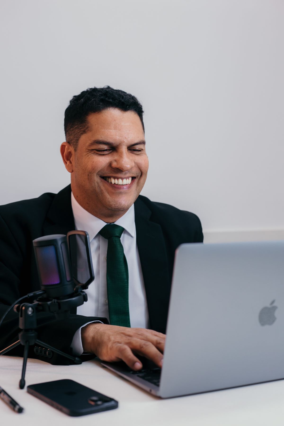 Smiling businessman working on a laptop in an office, using Salesforce from a chat interface