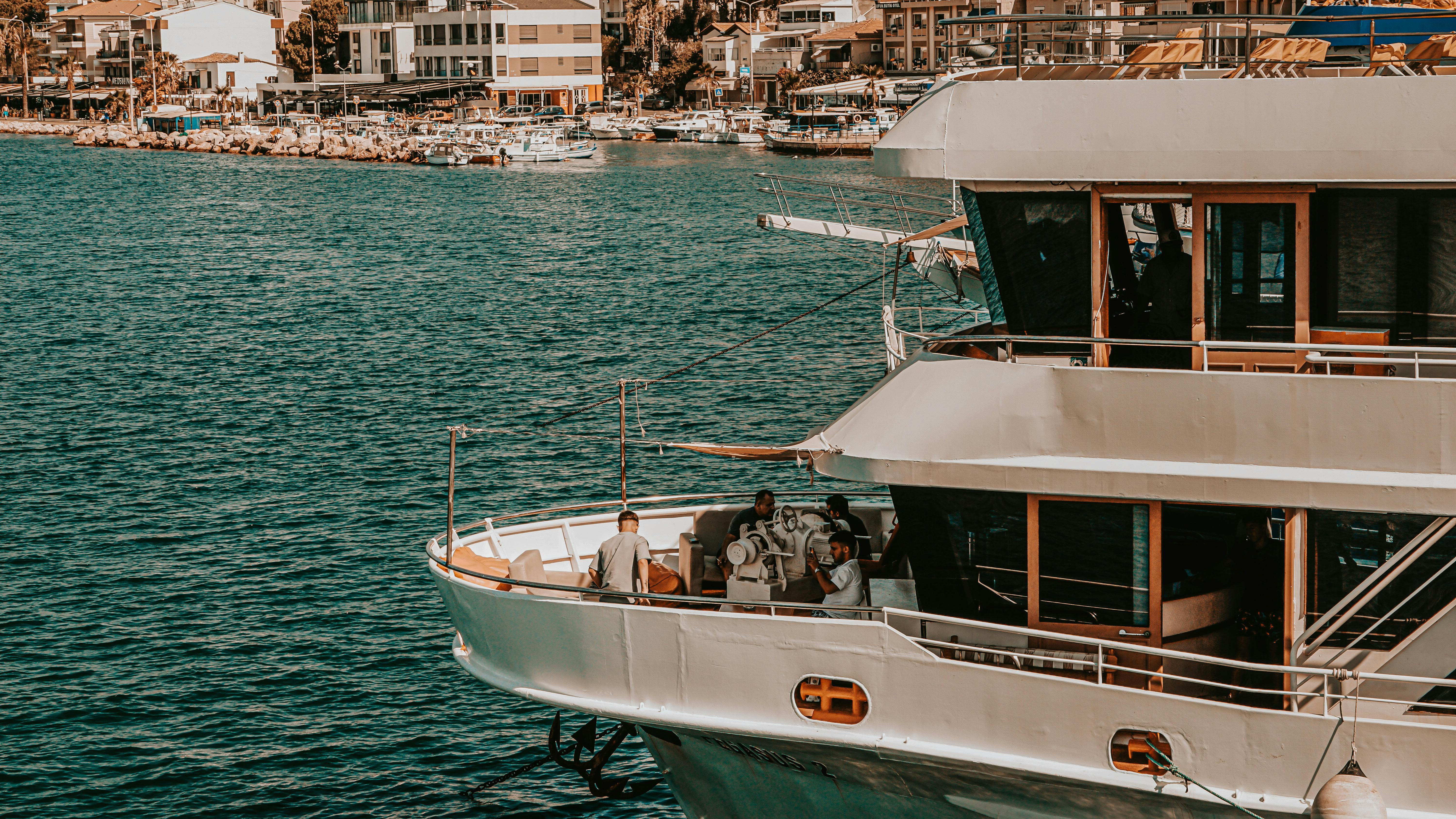 a boat is docked in the water near a city