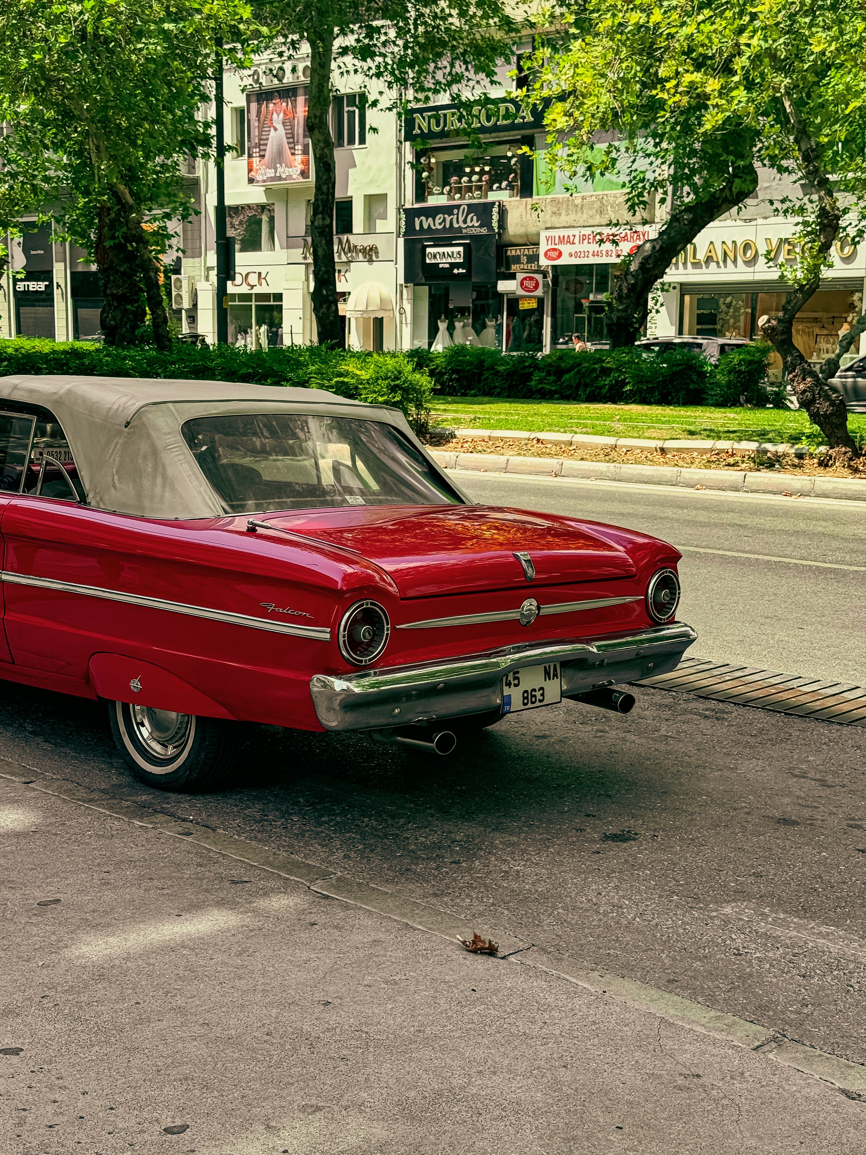 A red classic car parked on the side of the road · Free Stock Photo