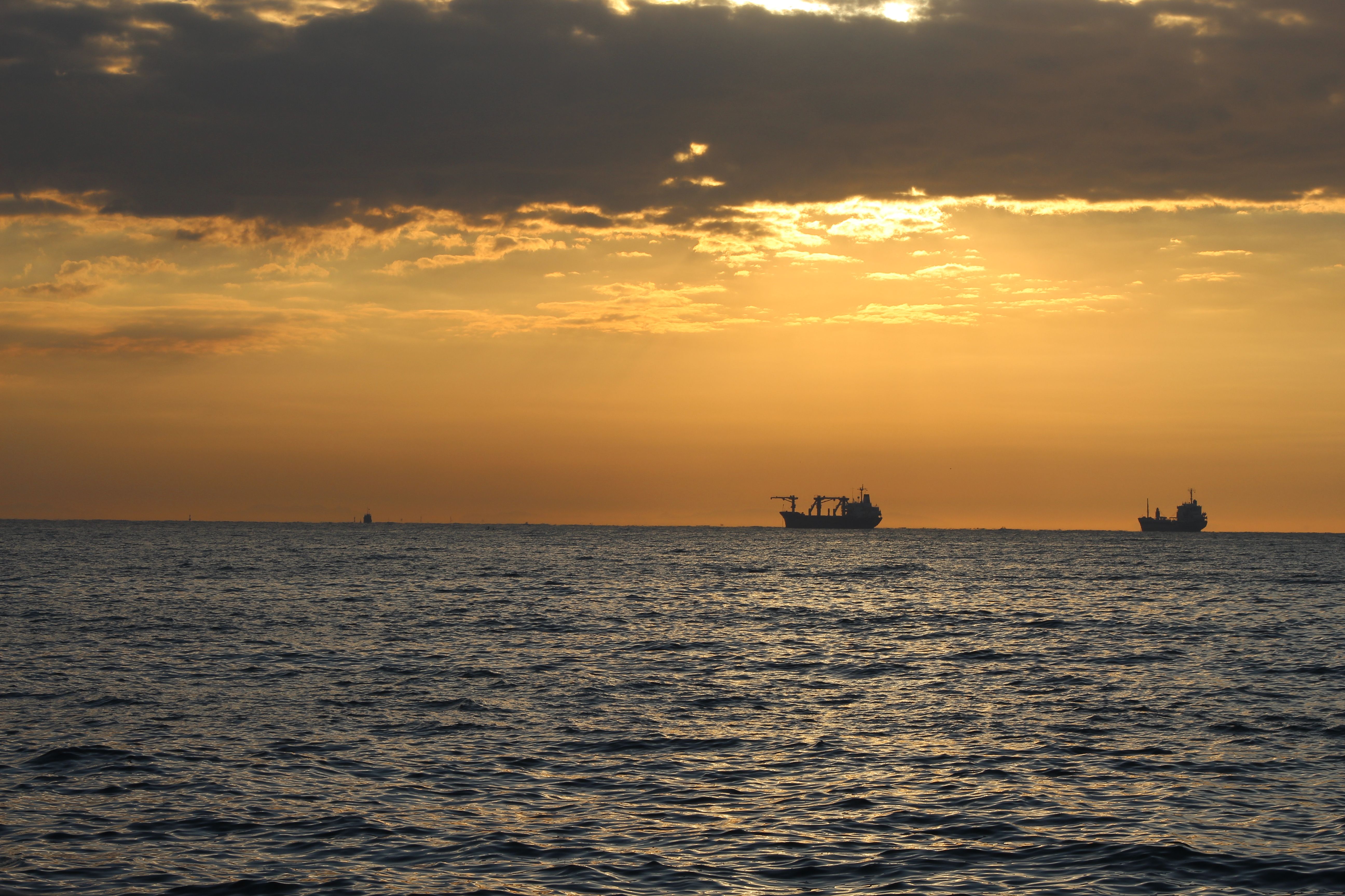 Silhouettes of Ships at Sea During Sunset · Free Stock Photo