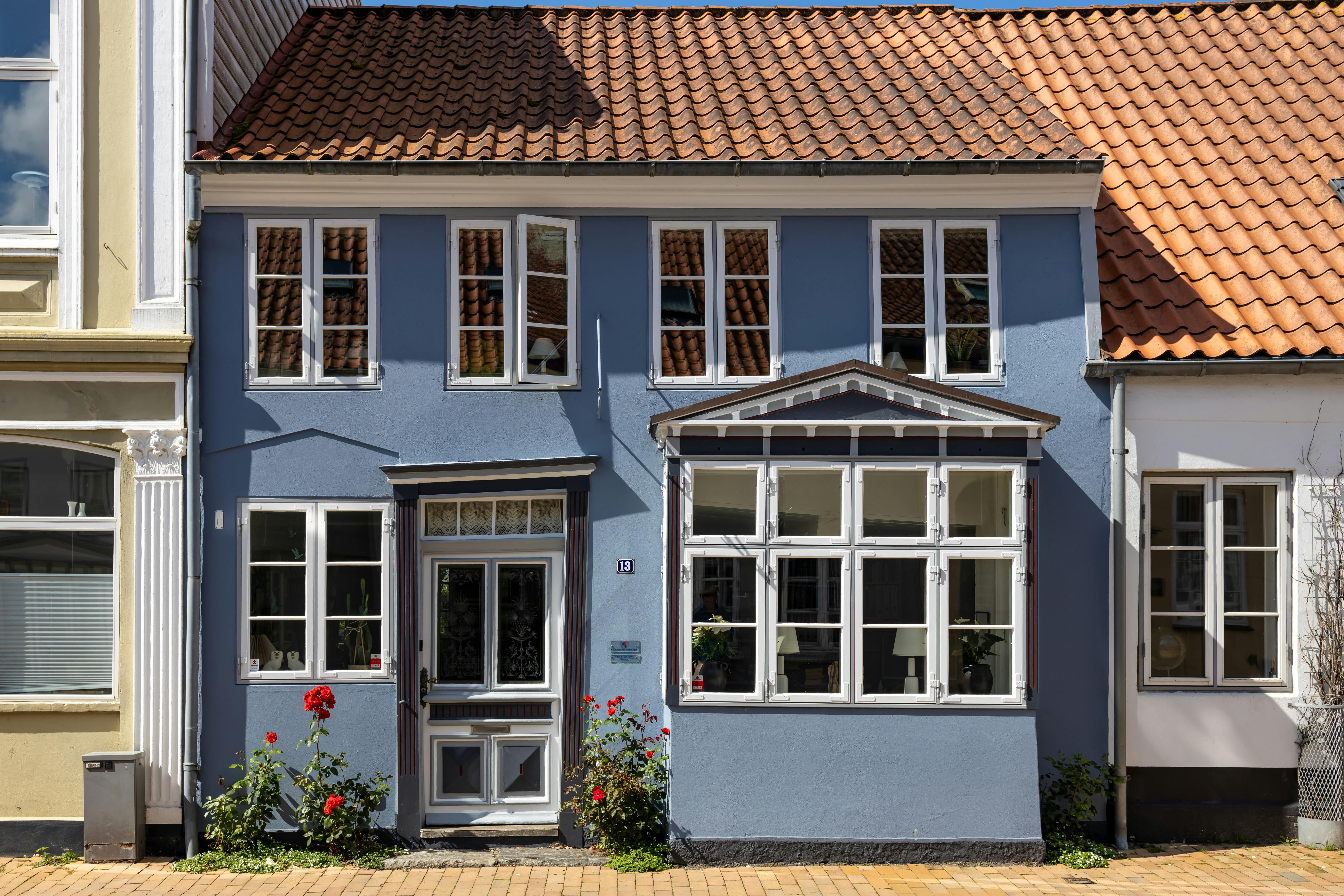 A picturesque blue house with traditional Danish architecture in the heart of Tondern, Denmark.