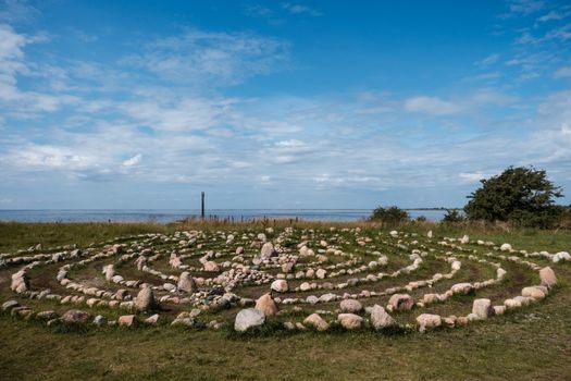 A large circular stone maze in the middle of a field