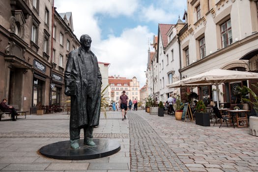 View of a bustling street with a statue in Tallinn, Estonia. Perfect for urban and travel themes.