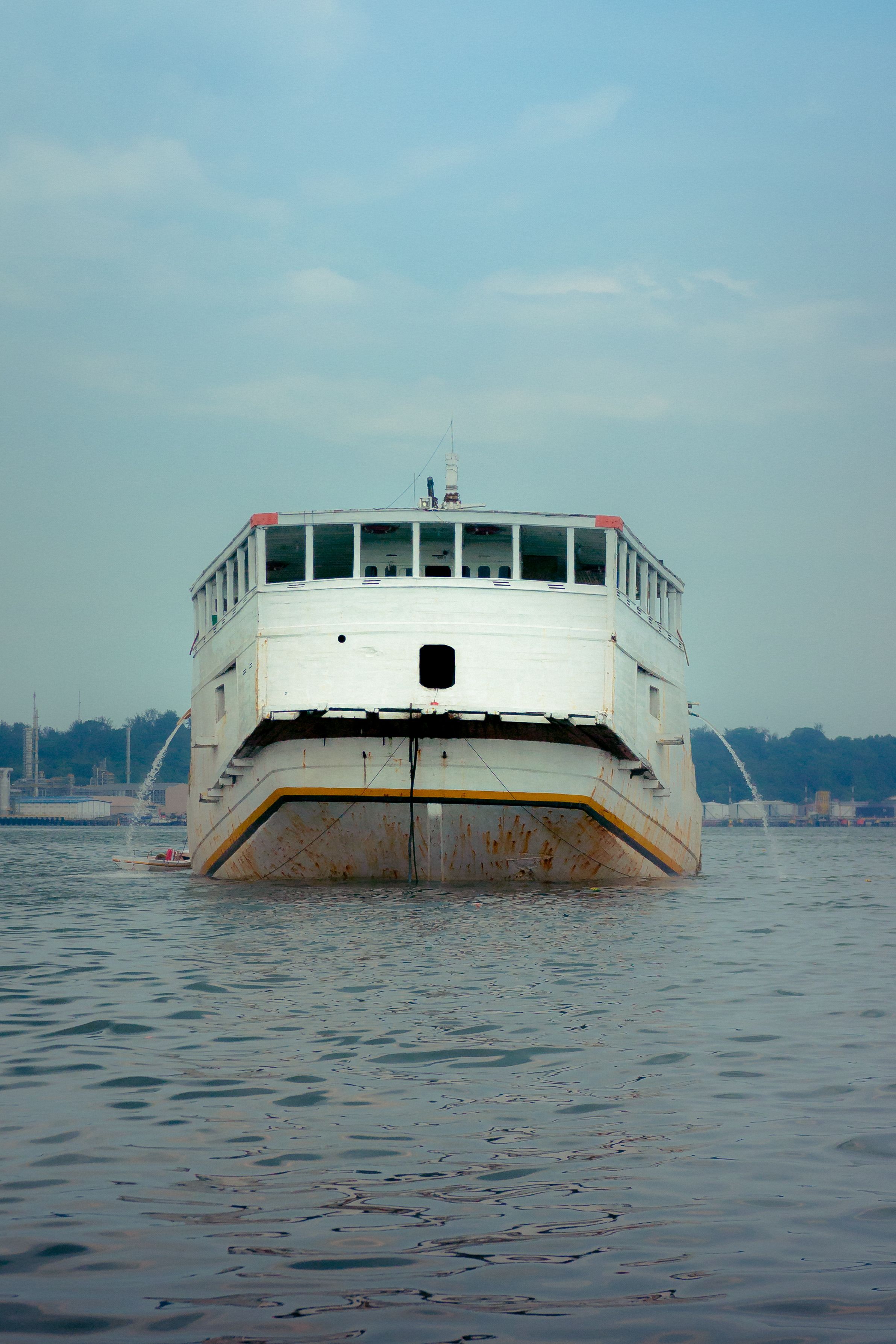 A large boat is floating in the water · Free Stock Photo
