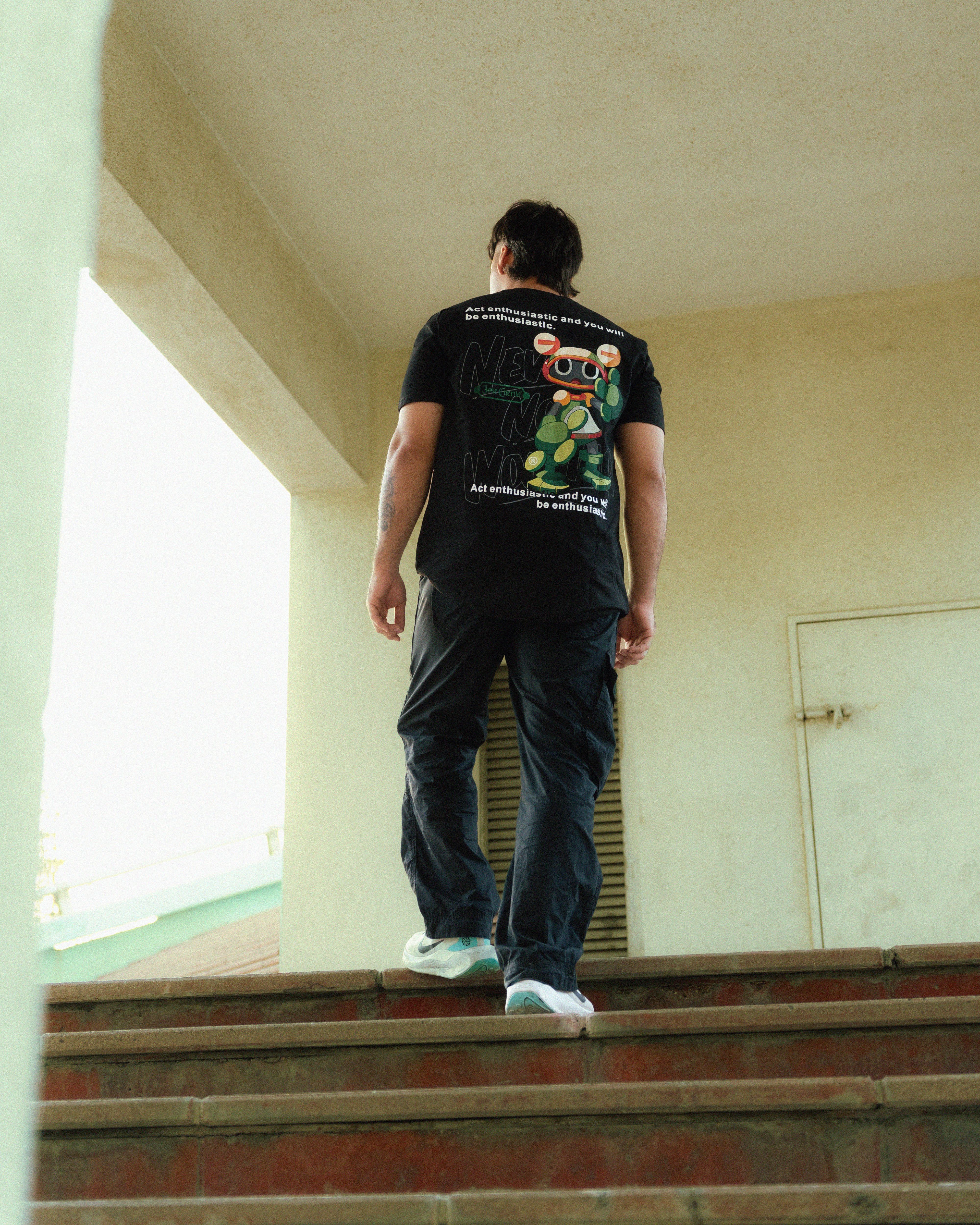 Grit Tee. Oversized black graphic tee, back view