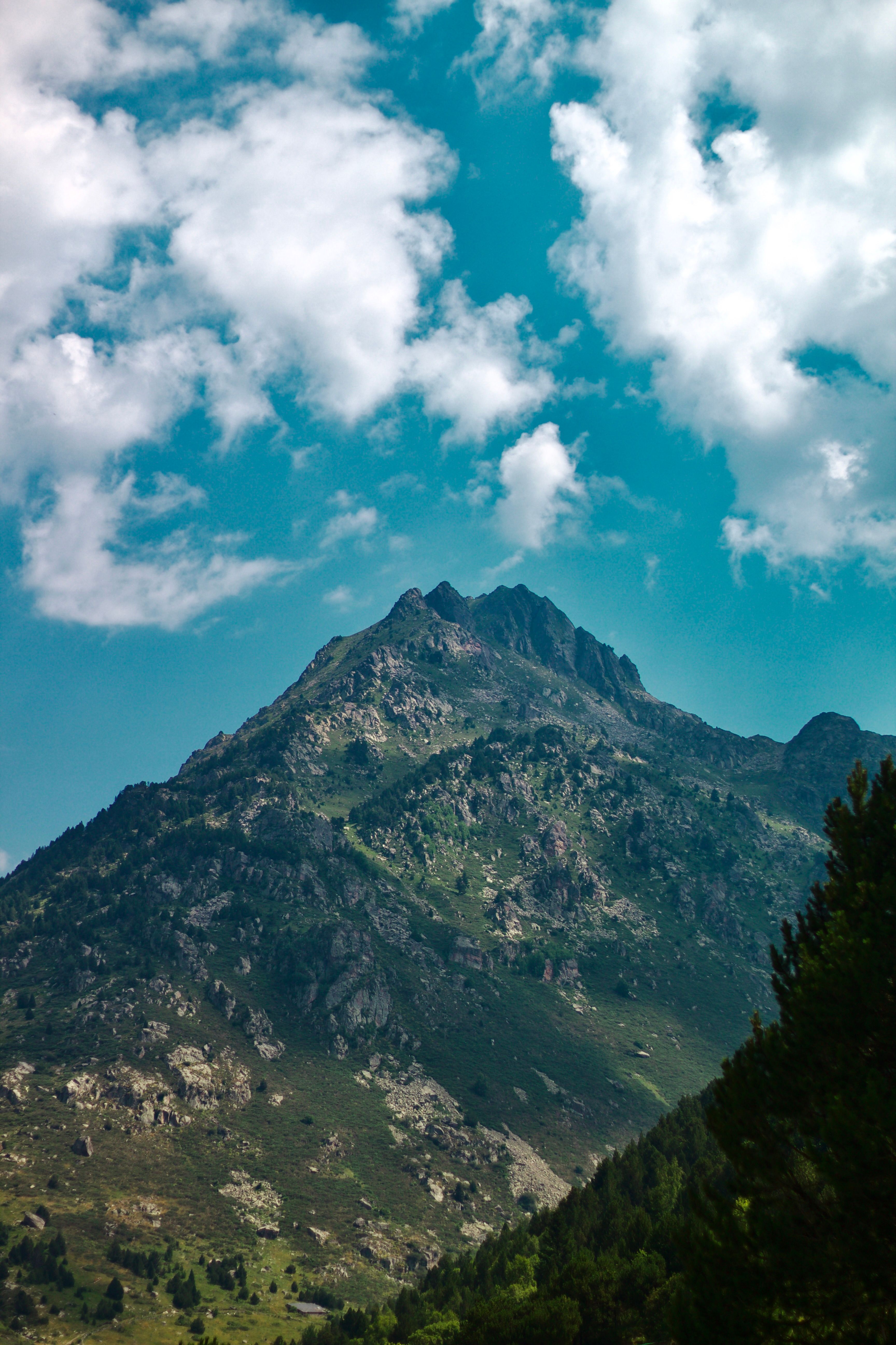 Breathtaking view of a majestic mountain peak under a vibrant blue sky in Andorra la Vella.