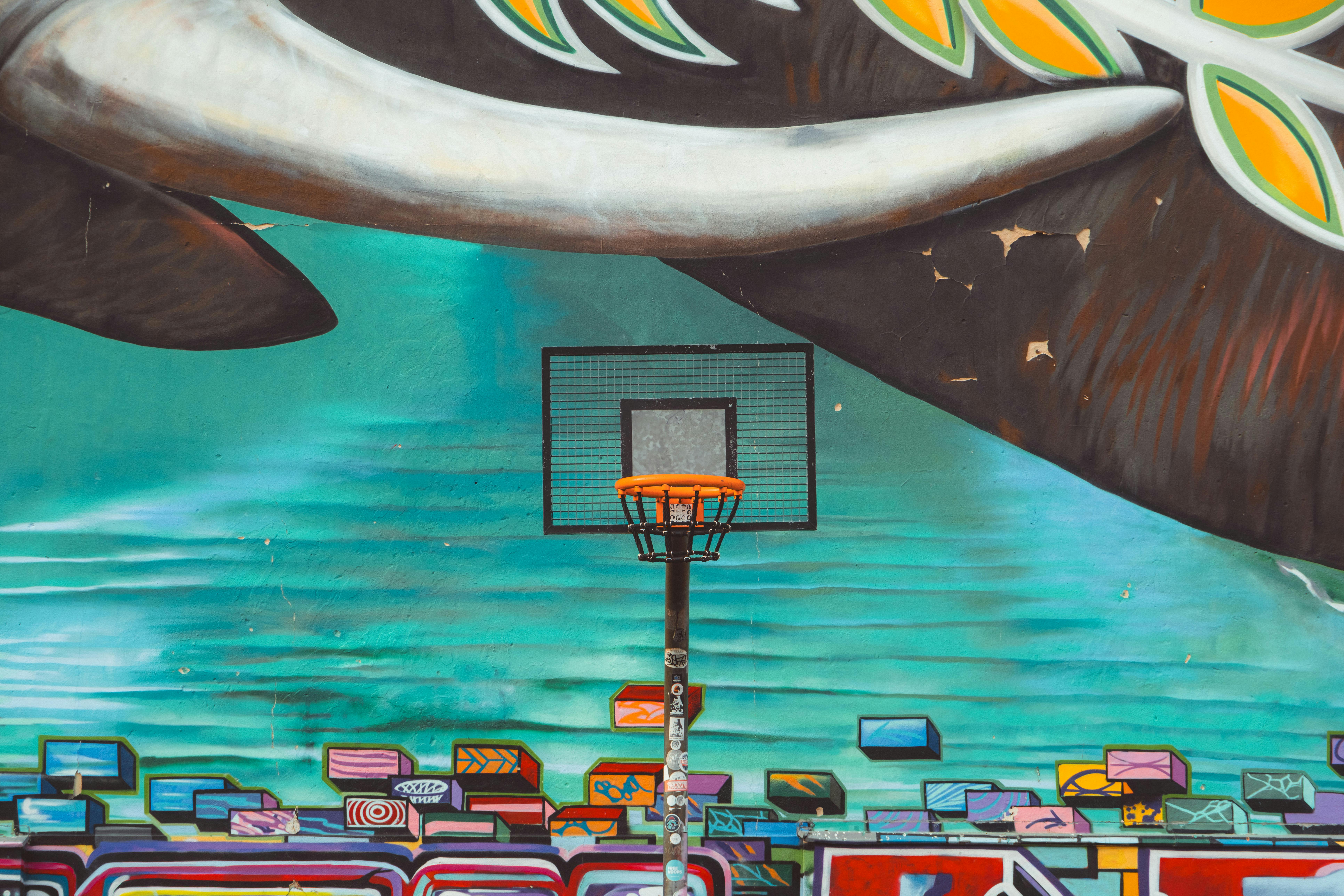 a basketball hoop painted on a wall with a whale