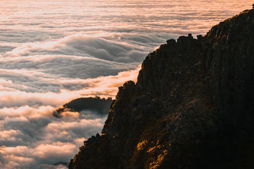 Free Stunning view of Madeira's mountains above a sea of clouds at sunrise. Stock Photo