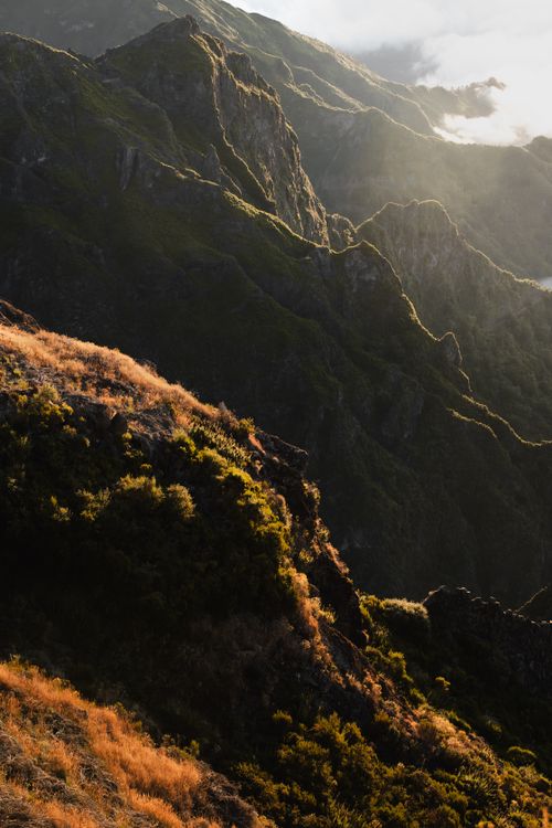 Free Warm light illuminating the rugged peaks of Madeira, Portugal, with lush greenery. Stock Photo