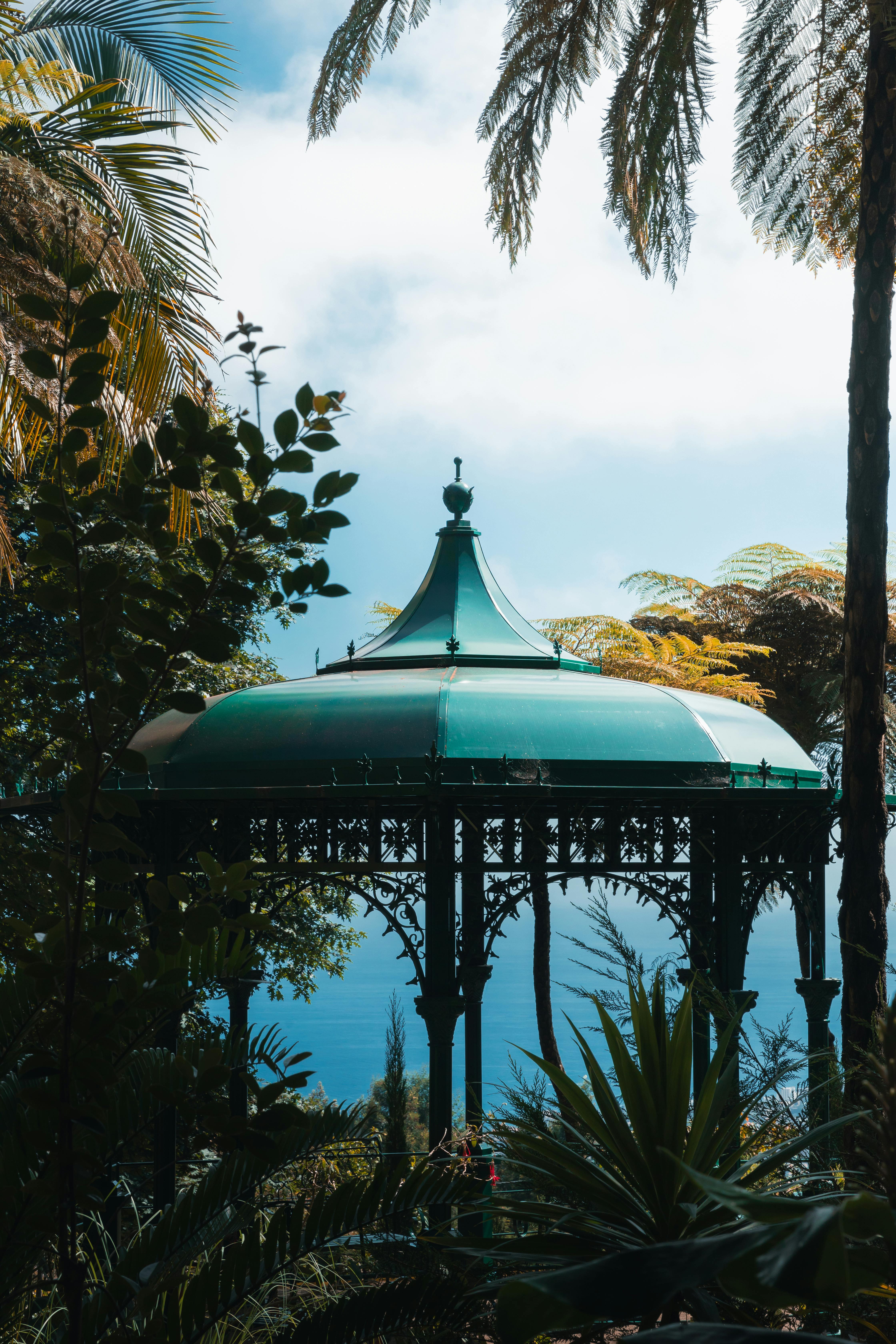 a gazebo in the middle of a tropical garden