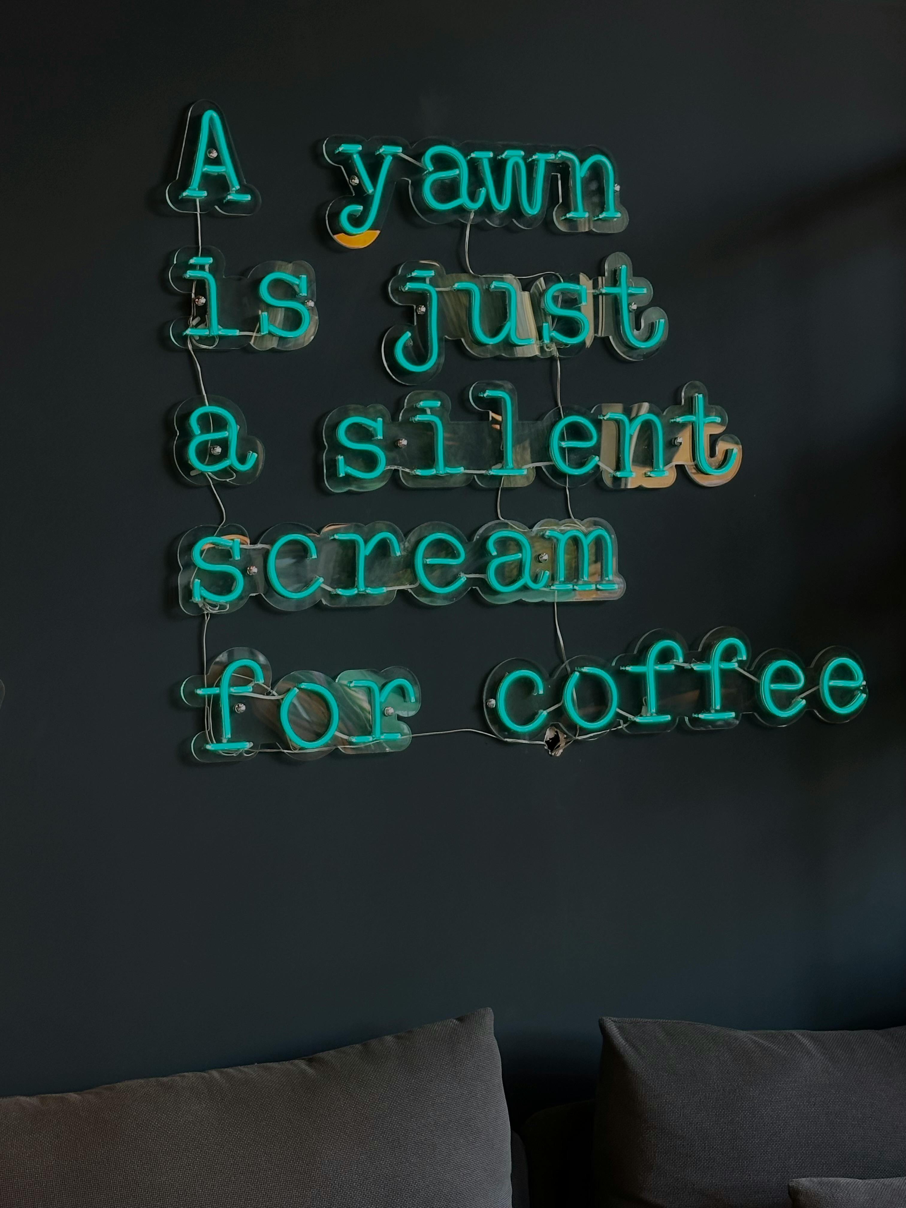 a sign that says yawn is just silent scream for coffee