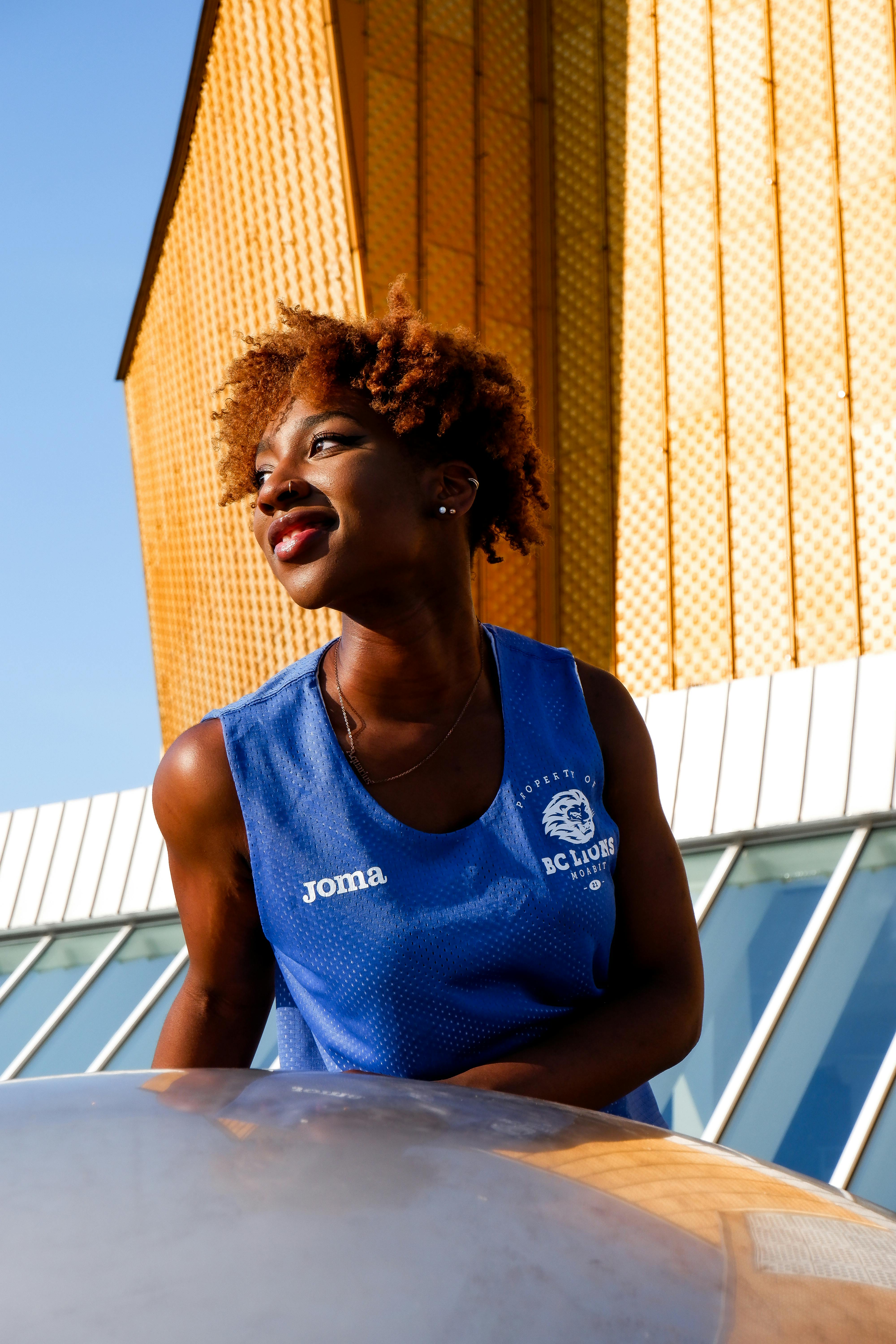 Portrait of a smiling woman enjoying a sunny day outdoors in Berlin, showcasing summer vibes.
