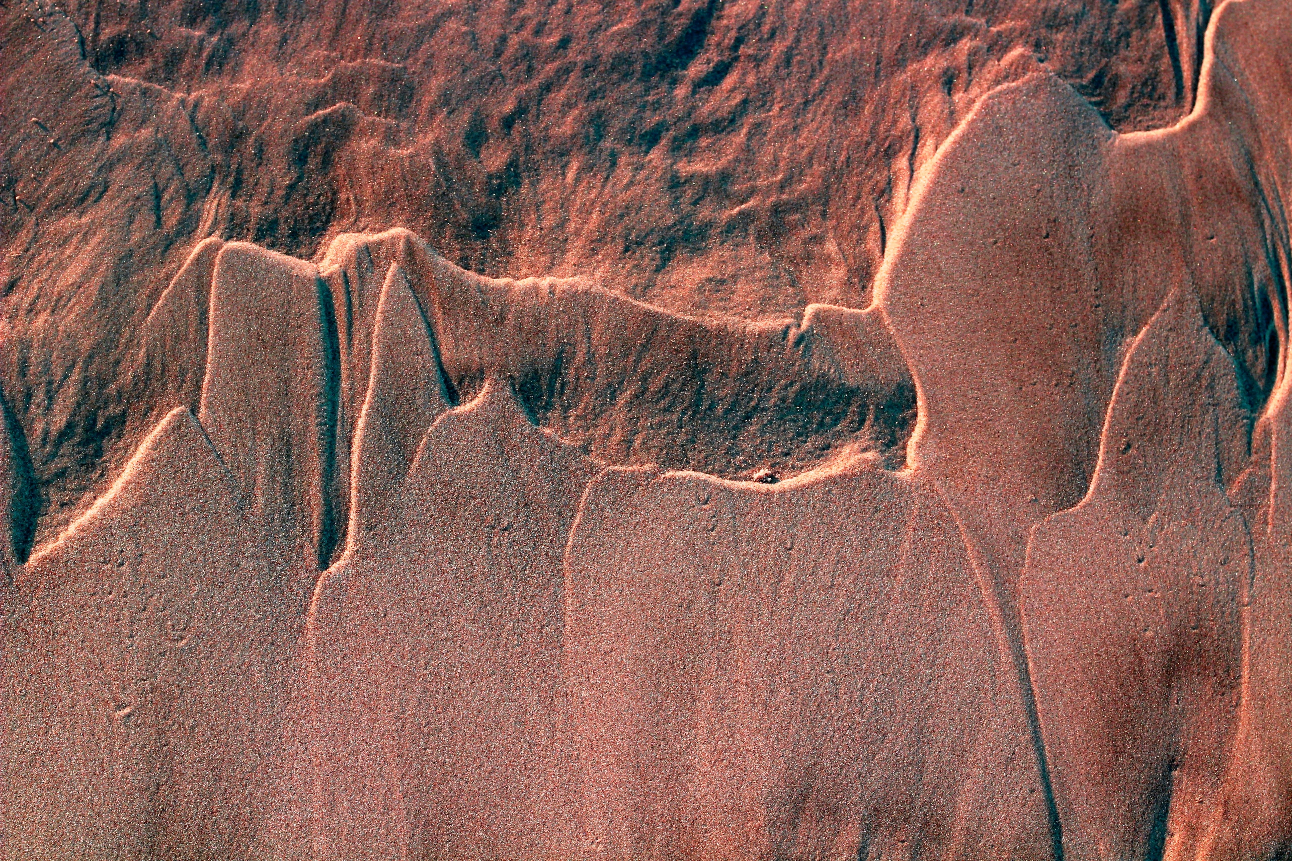 Artistic shot of wind-blown sand patterns on Guaratuba Beach, Brazil.