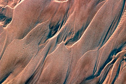 An aerial view of sand and water