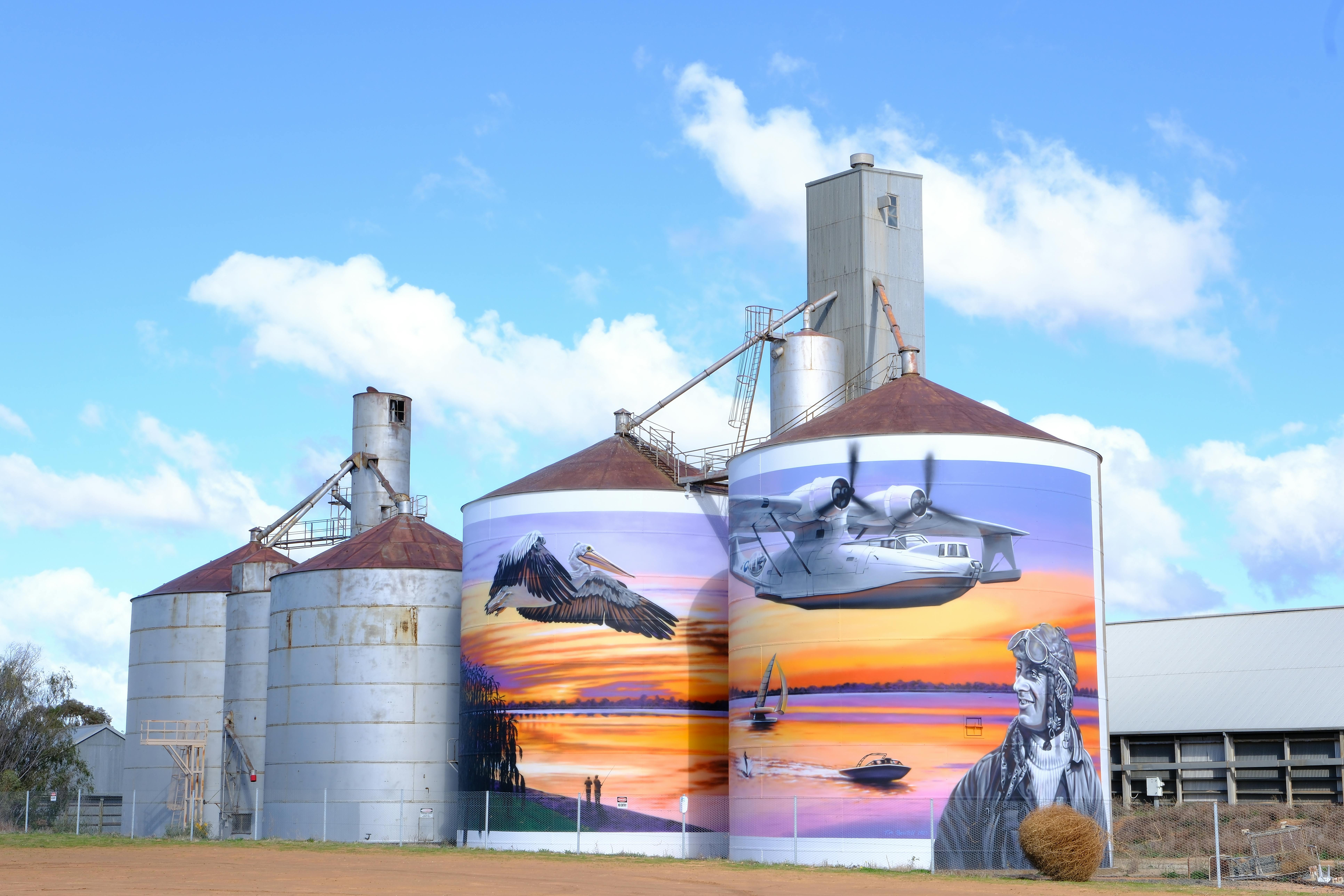 A large mural on the side of a grain silo