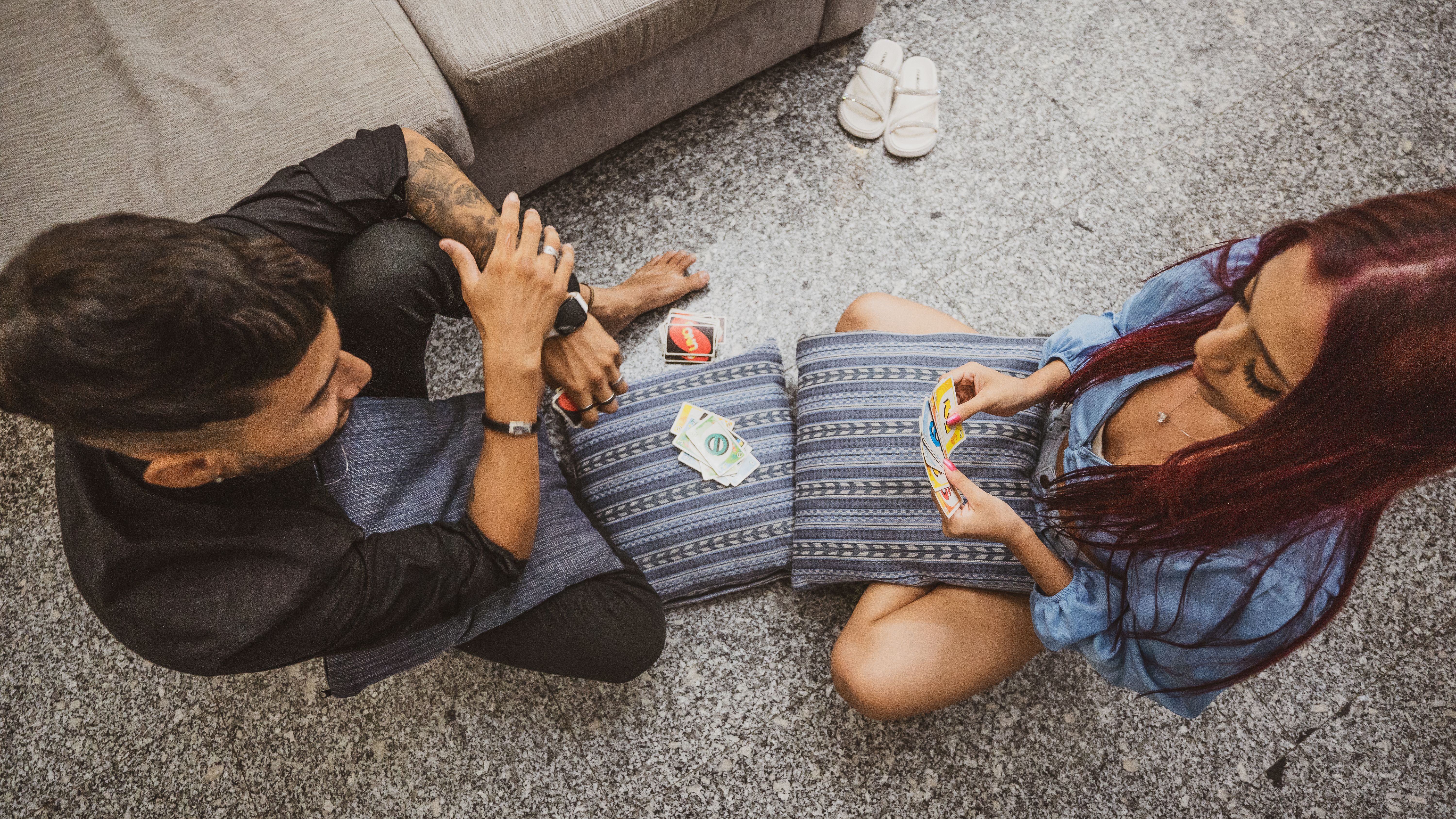 couple playing interactive card games on floor