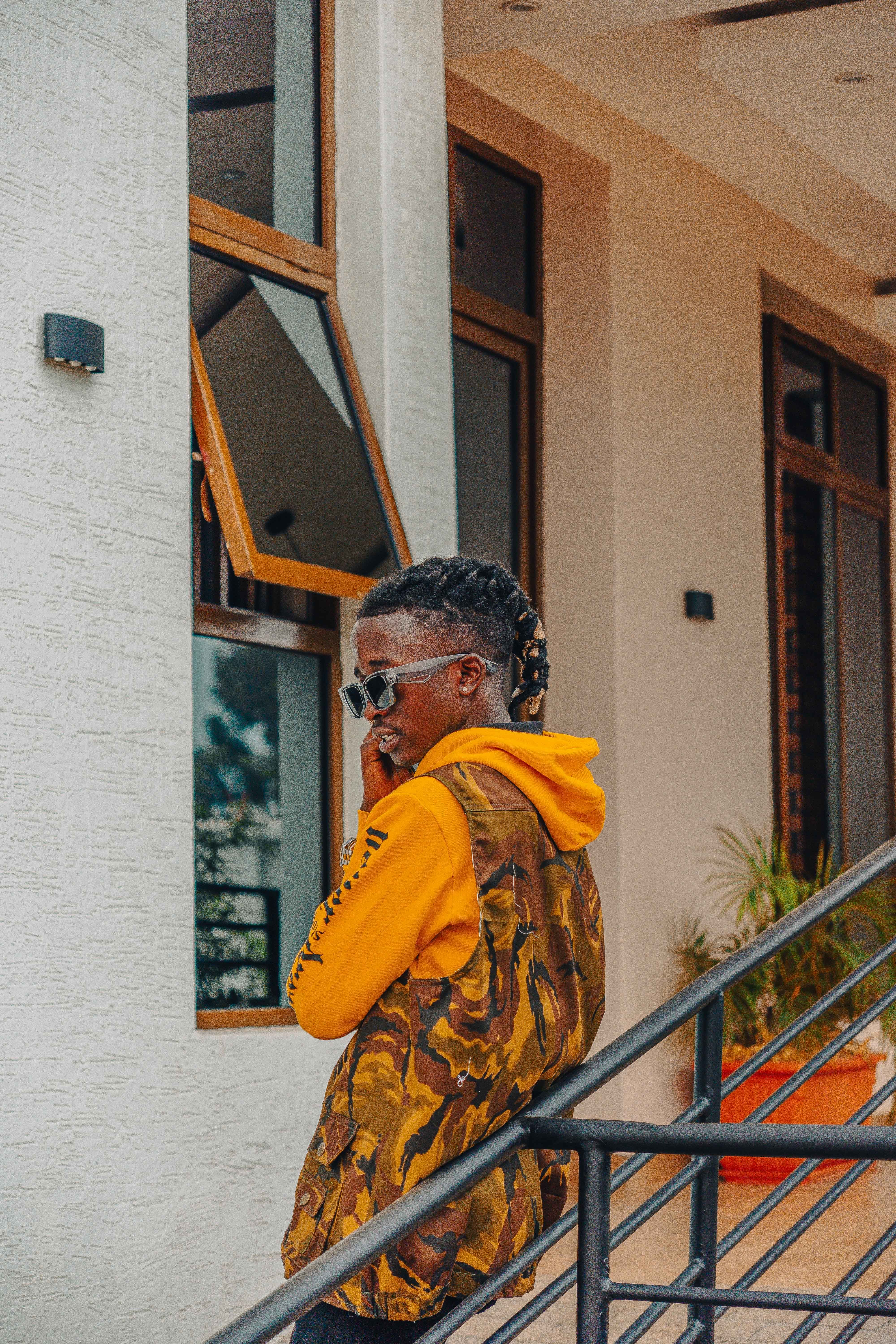 Stylish young man in a vibrant urban environment wearing fashionable attire.