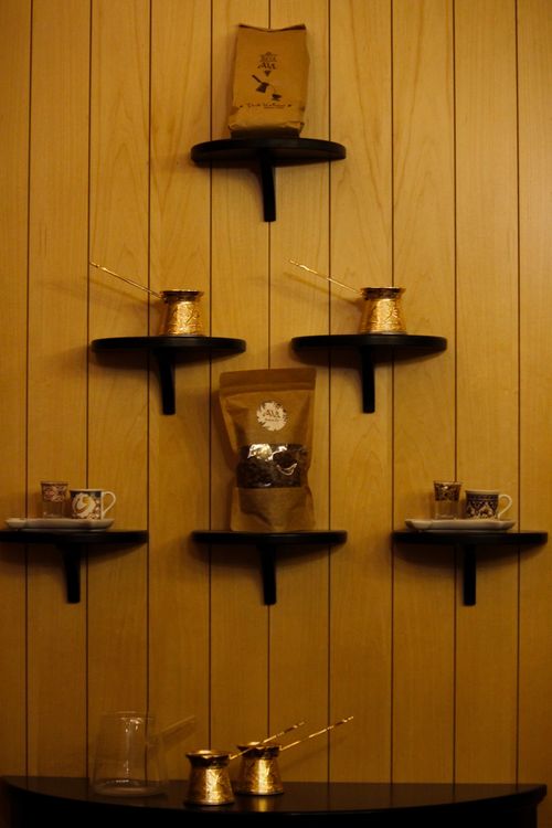 Free An artistic display of Turkish coffee cups and pots on modern wooden wall shelves. Stock Photo