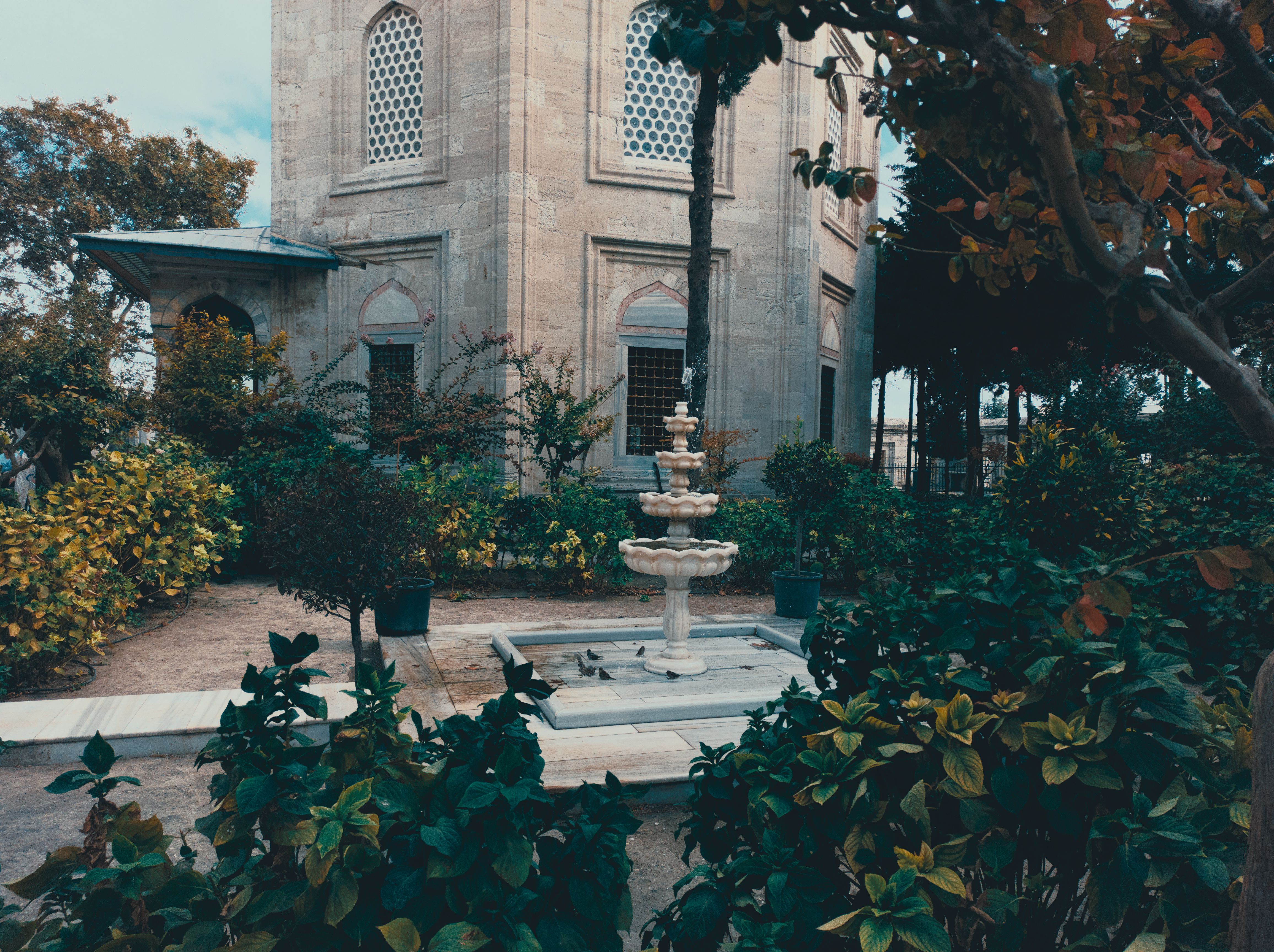 Explore the serene Ottoman garden with a historic fountain at a cemetery in Istanbul, Turkey.