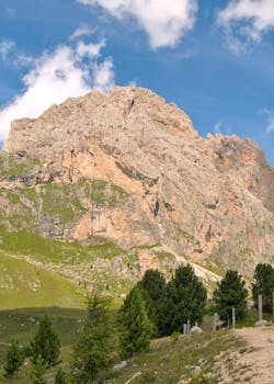 Breathtaking landscape of Santa Cristina Valgardena with towering mountain and lush greenery.