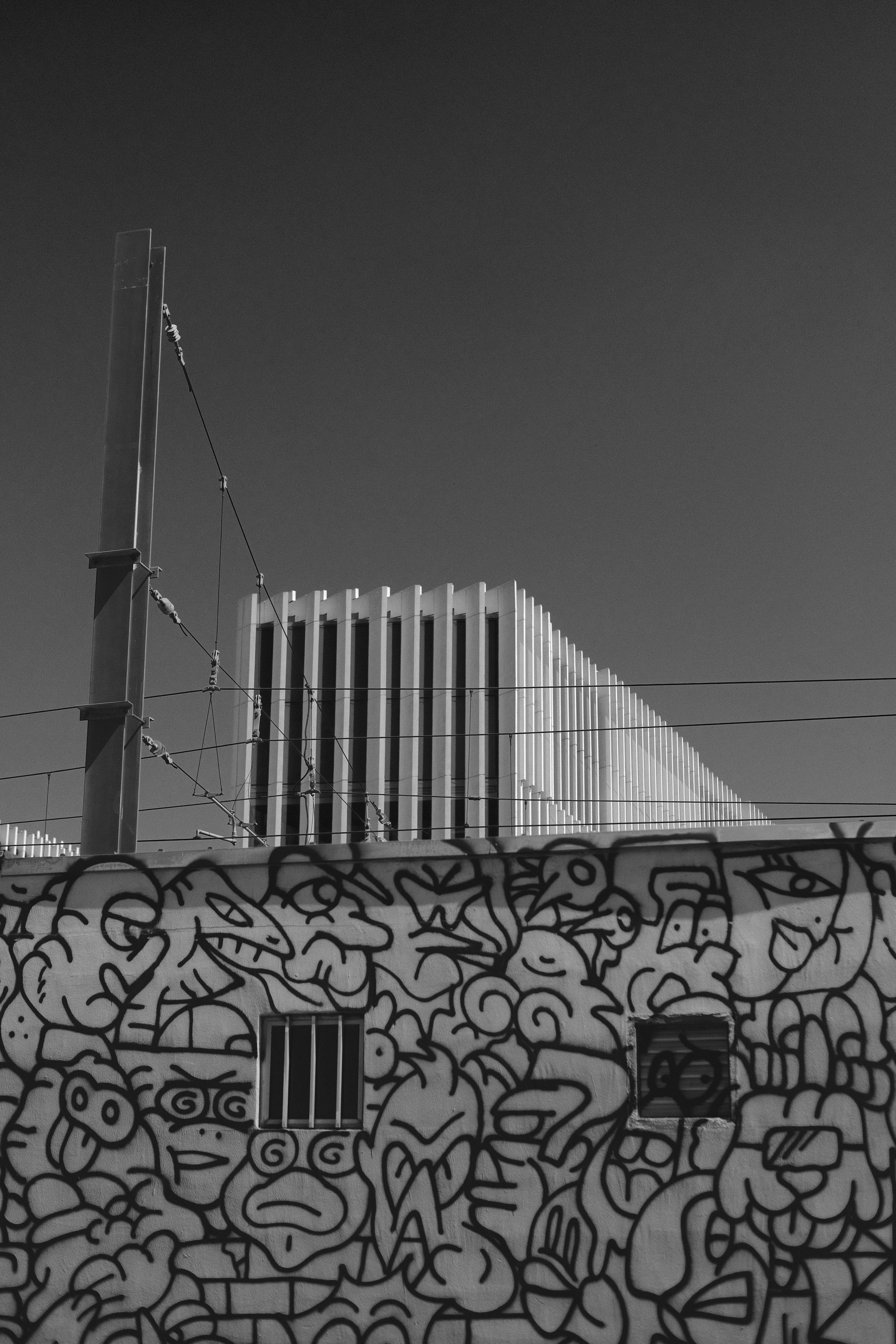 Black and white photograph of graffiti art on a wall in Lisbon, Portugal.