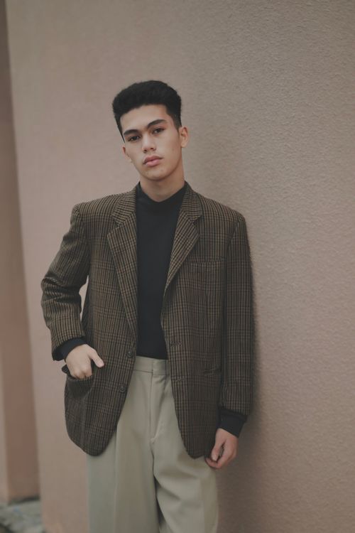 Free Portrait of a fashionable man wearing a vintage blazer and trousers indoors. Stock Photo