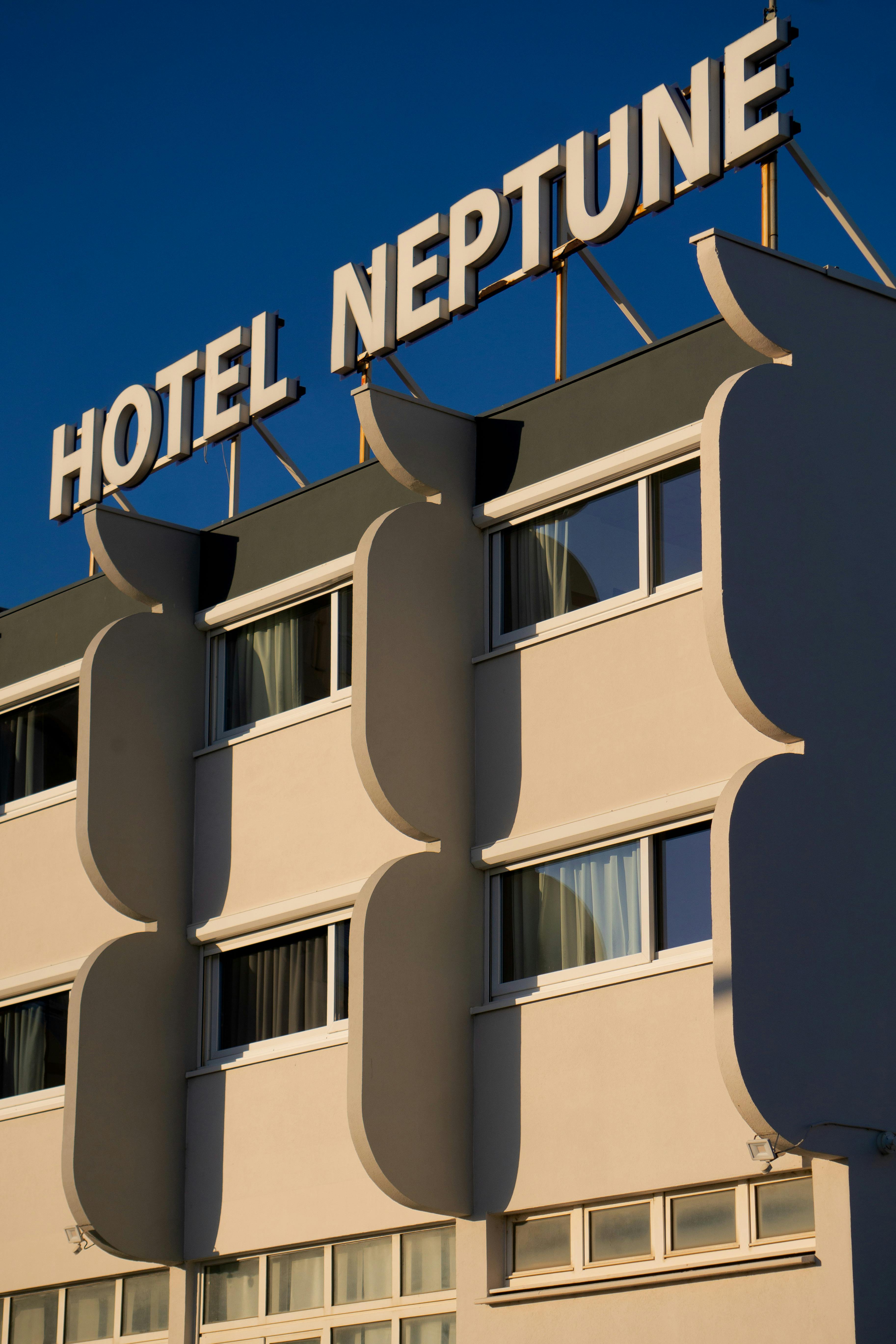 Contemporary hotel facade against a clear blue sky, highlighting modern architecture.