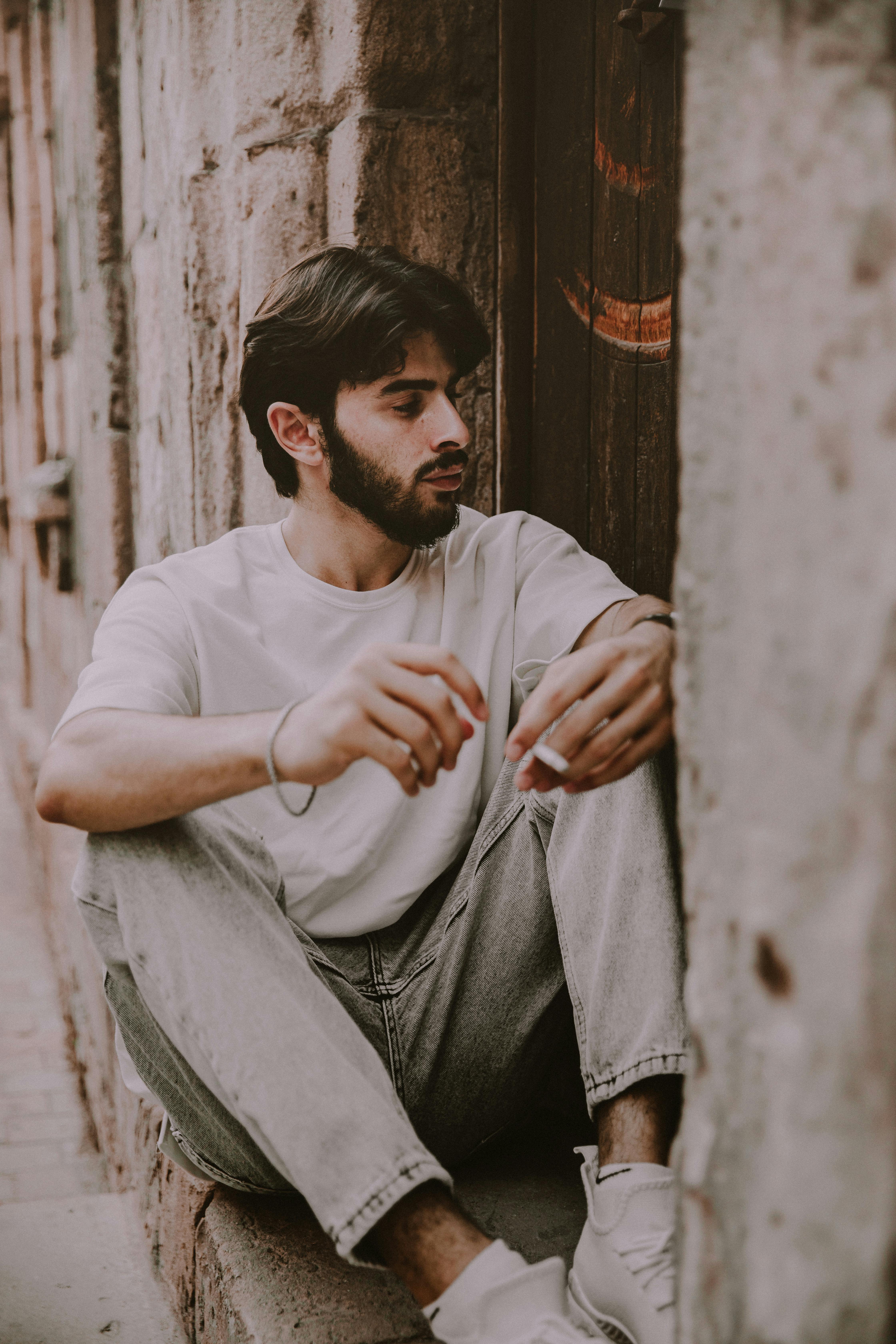 a man sitting on the steps of an old building