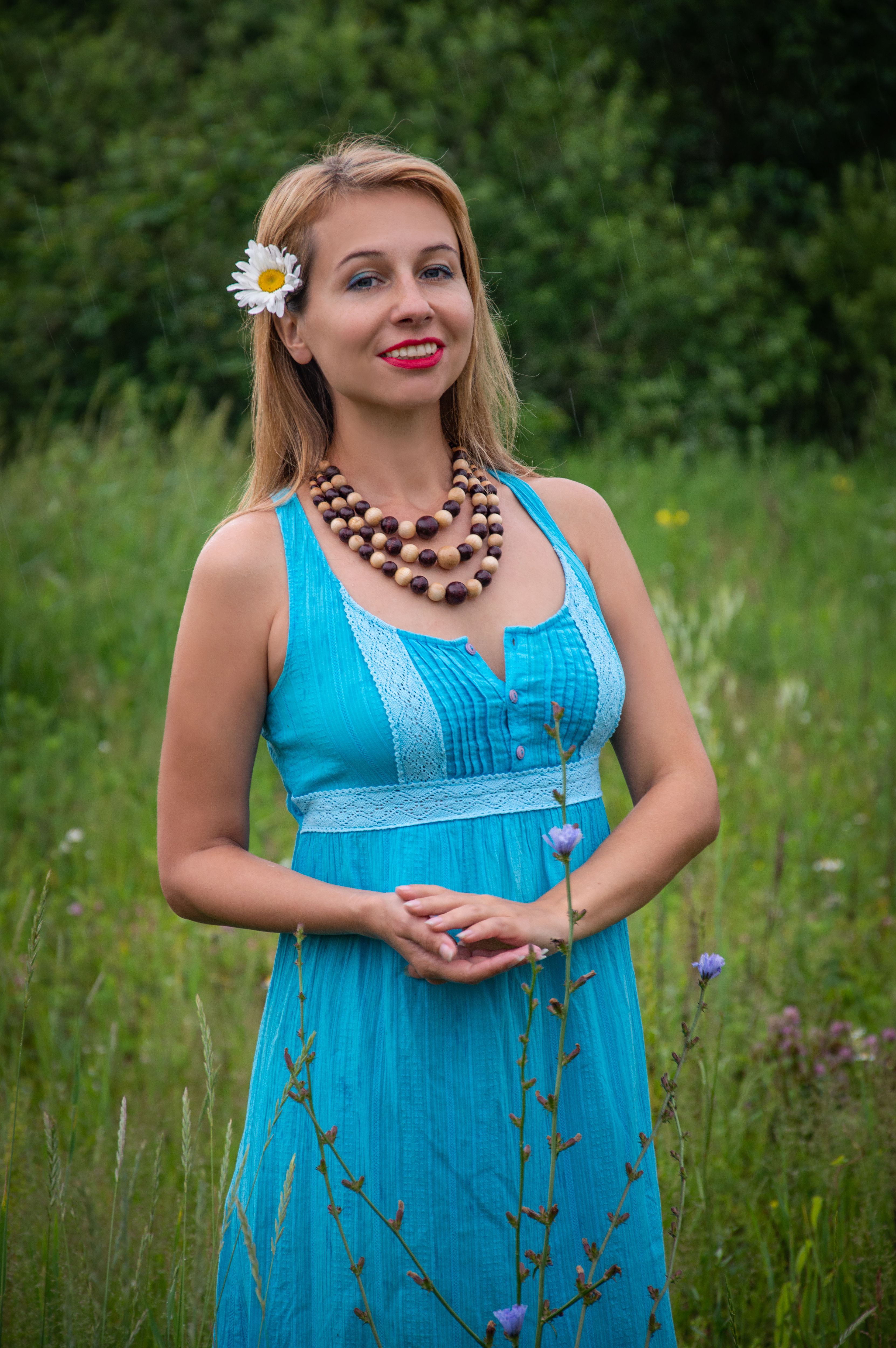 A woman in a blue dress standing in a field · Free Stock Photo