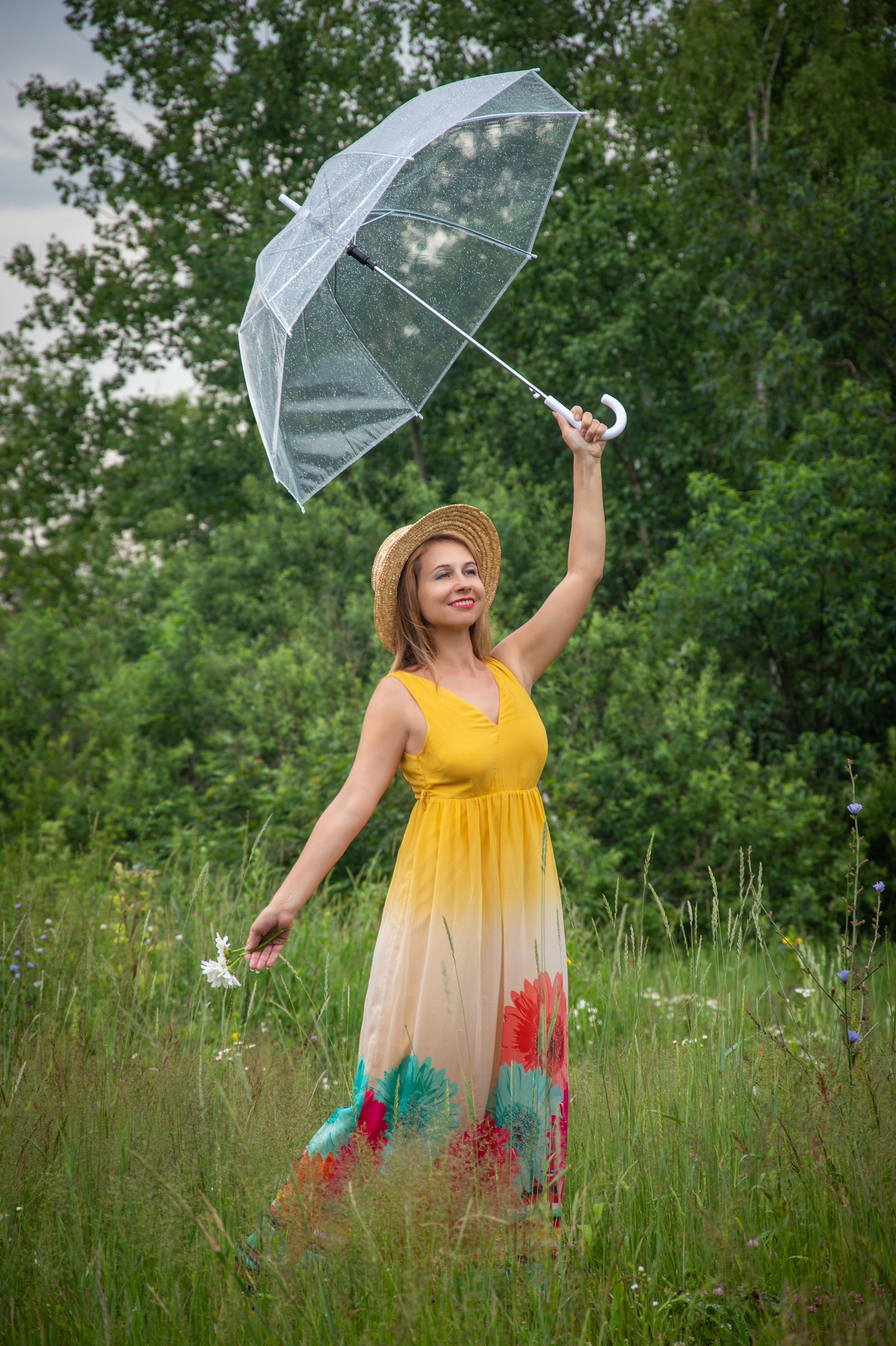 A woman in a yellow dress holding an umbrella · Free Stock Photo