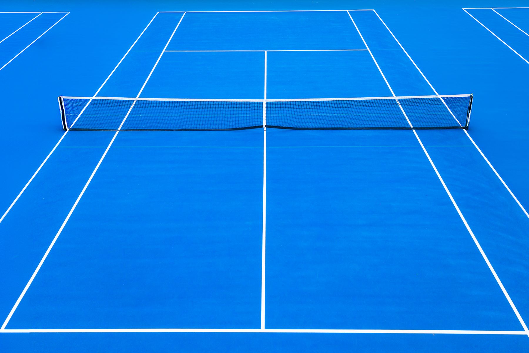 Overhead view of a blue tennis court with precise white lines