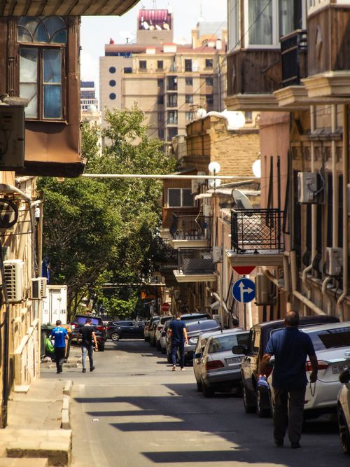 Free Bustling street scene in Baku with pedestrians and vehicles under daylight. Stock Photo