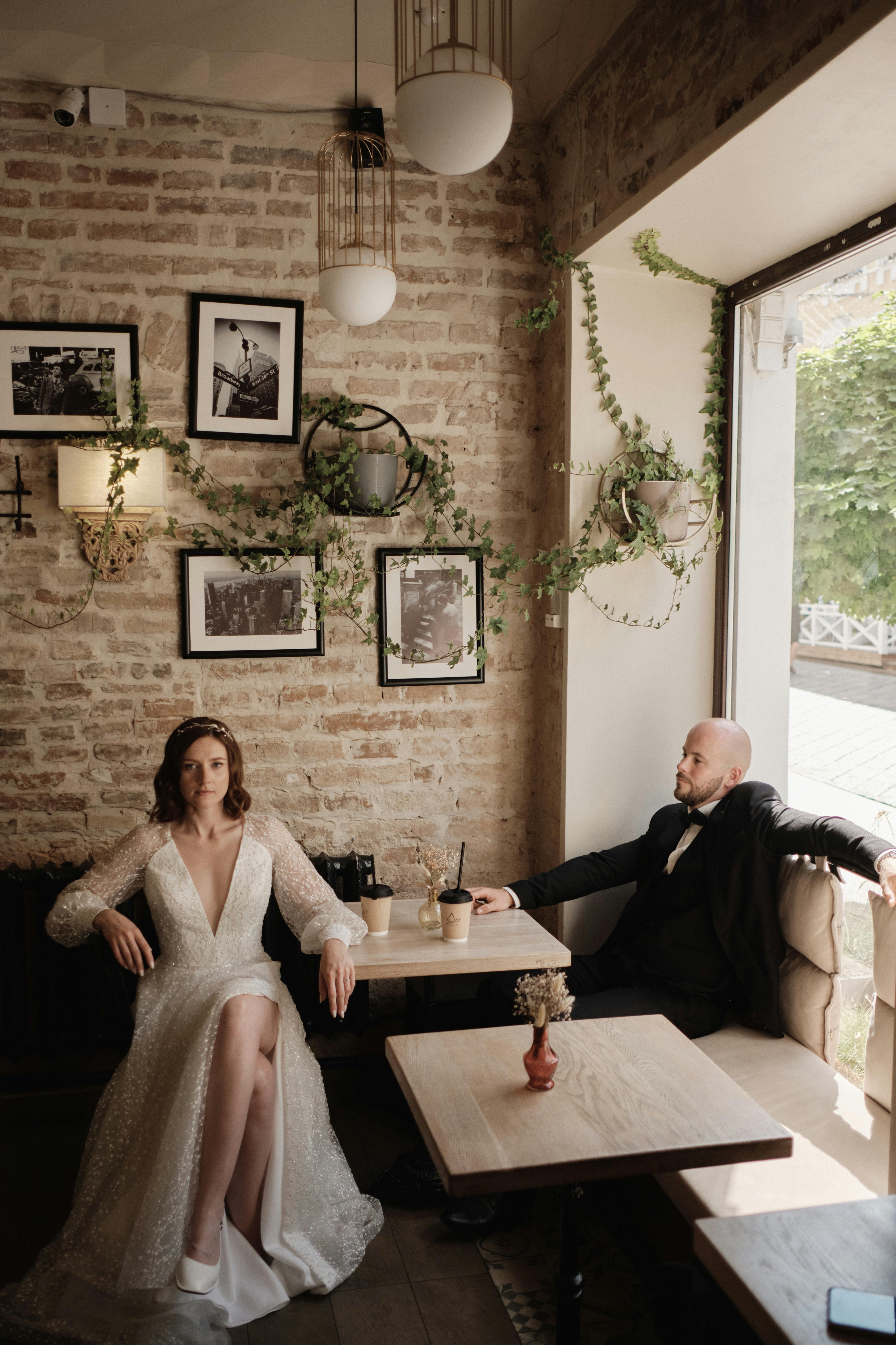 Elegant wedding couple in a vintage café, capturing a moment of stylish romance and sophistication.