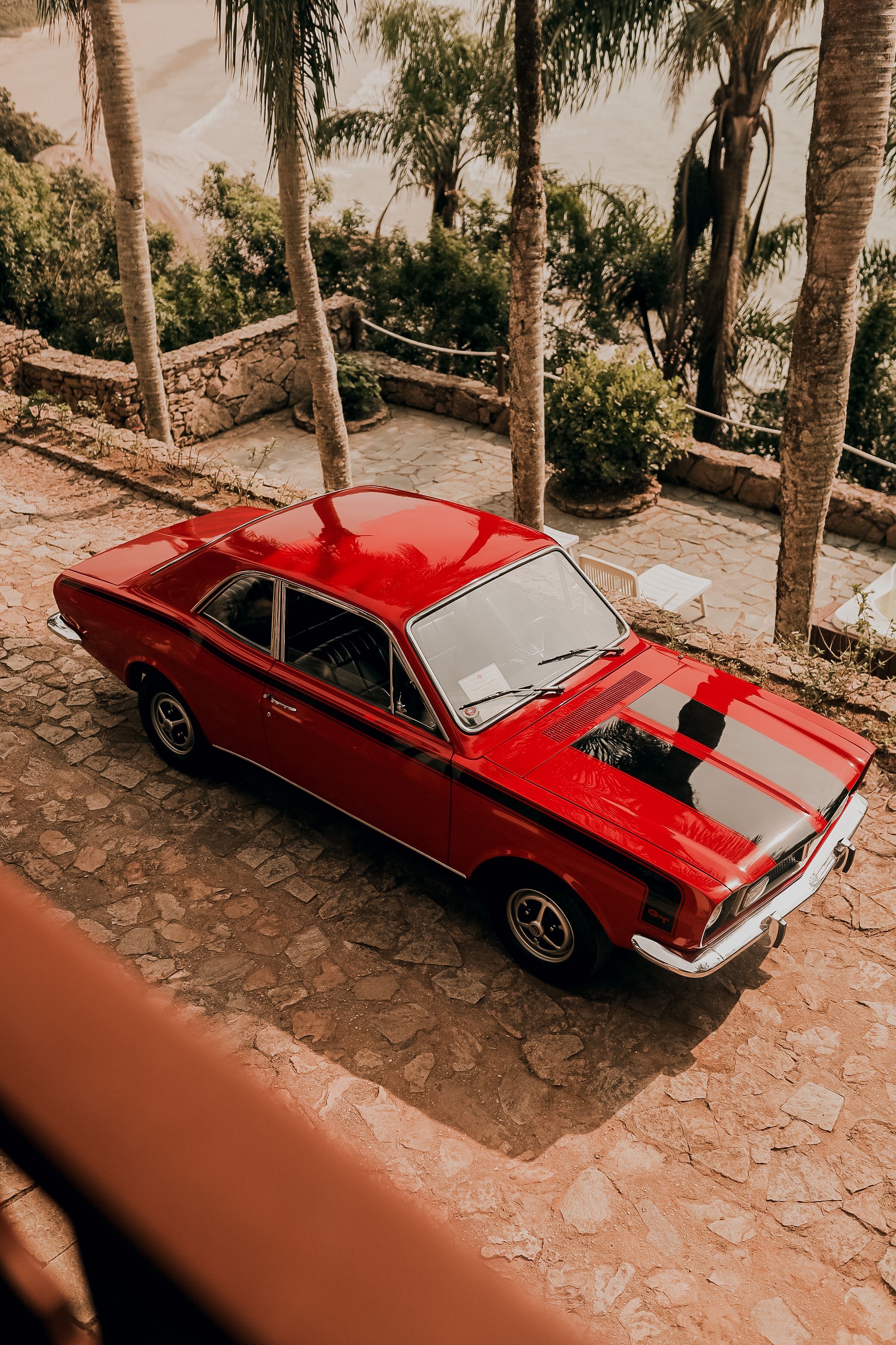 A red classic car parked on the side of the road · Free Stock Photo