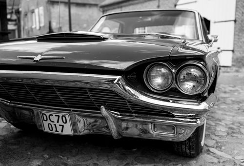 Free Close-up of a vintage car's front with chrome details, evoking nostalgia. Stock Photo