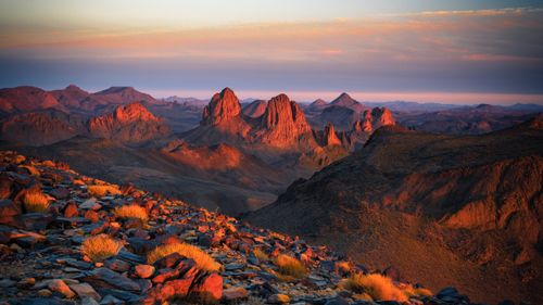 Free Capture the breathtaking sunset across the rocky terrains of Tamanrasset, Algeria. Stock Photo