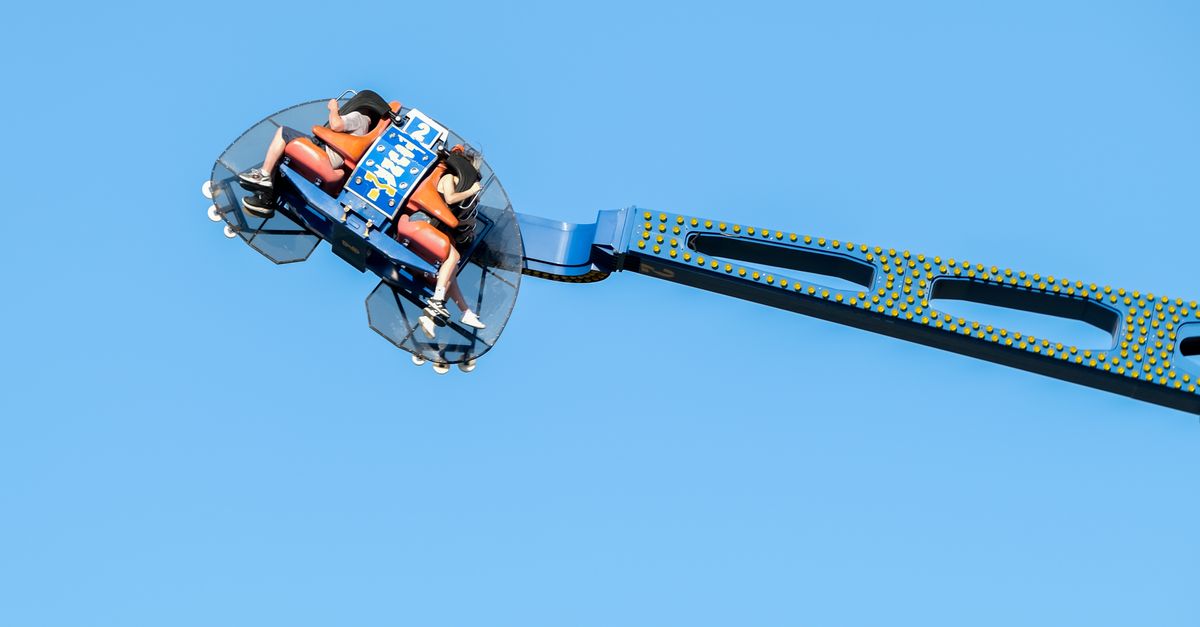 High Thrill Ride Soaring Against Clear Blue Sky · Free Stock Photo