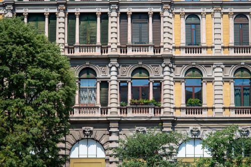 Free Detailed view of a neoclassical facade in Milan showcasing architectural elegance and classic style. Stock Photo