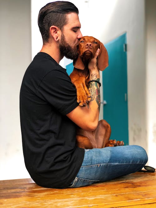 Free Photo of Man Kissing His Dog Stock Photo