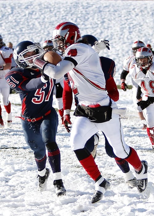 People Playing Football on Snow