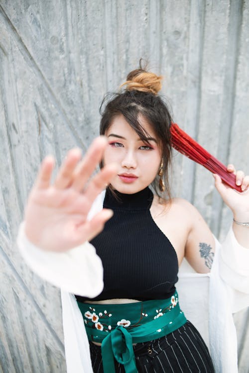 Photo of Woman Holding a Fan