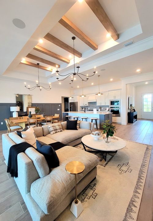 Free Spacious modern living room with luxurious decor and open kitchen area. Stock Photo