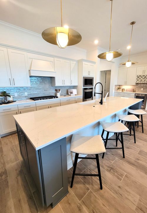Free Spacious modern kitchen featuring a marble island and contemporary design elements. Stock Photo