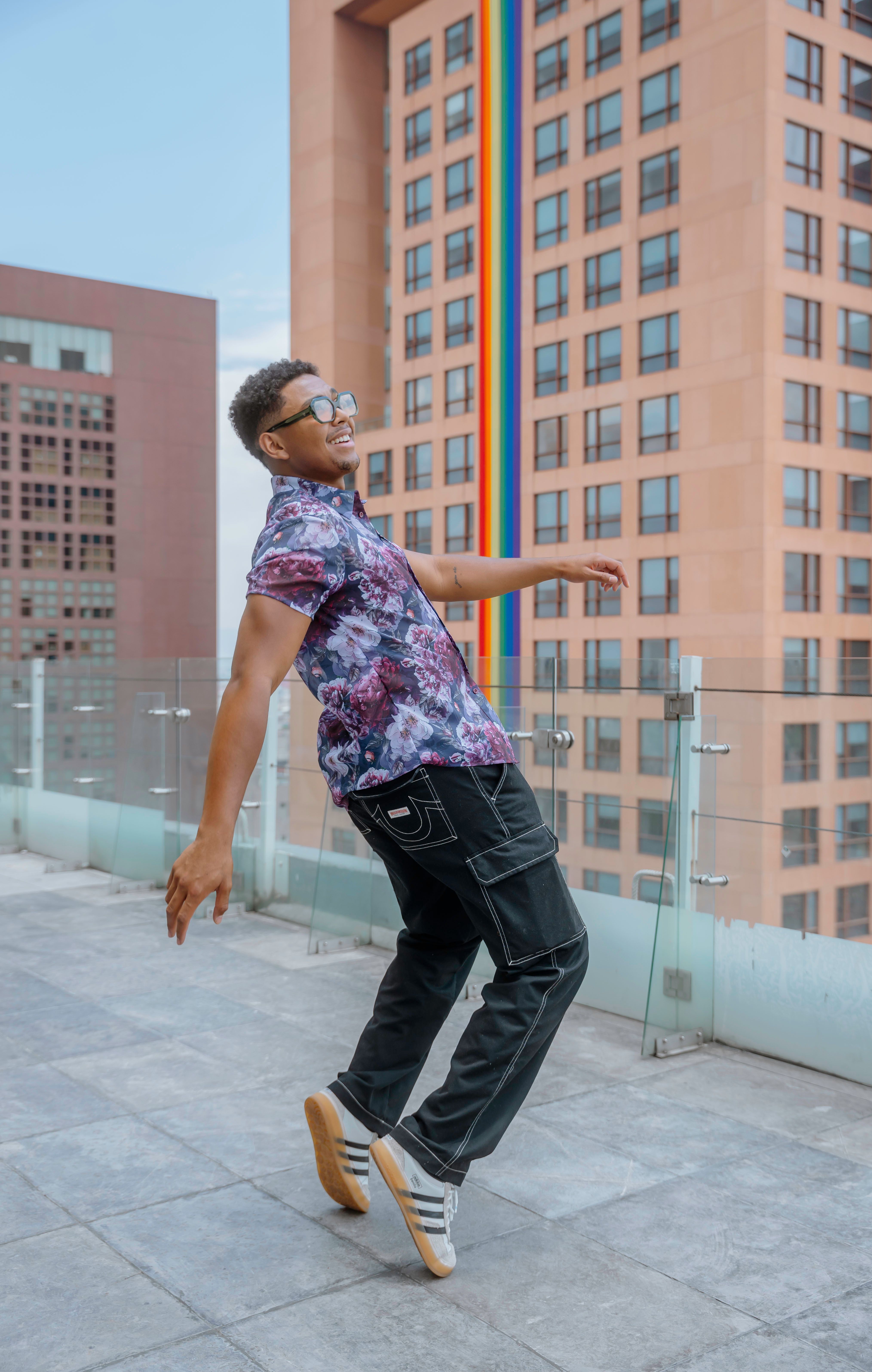 Smiling Man in Shirt Posing on Rooftop · Free Stock Photo