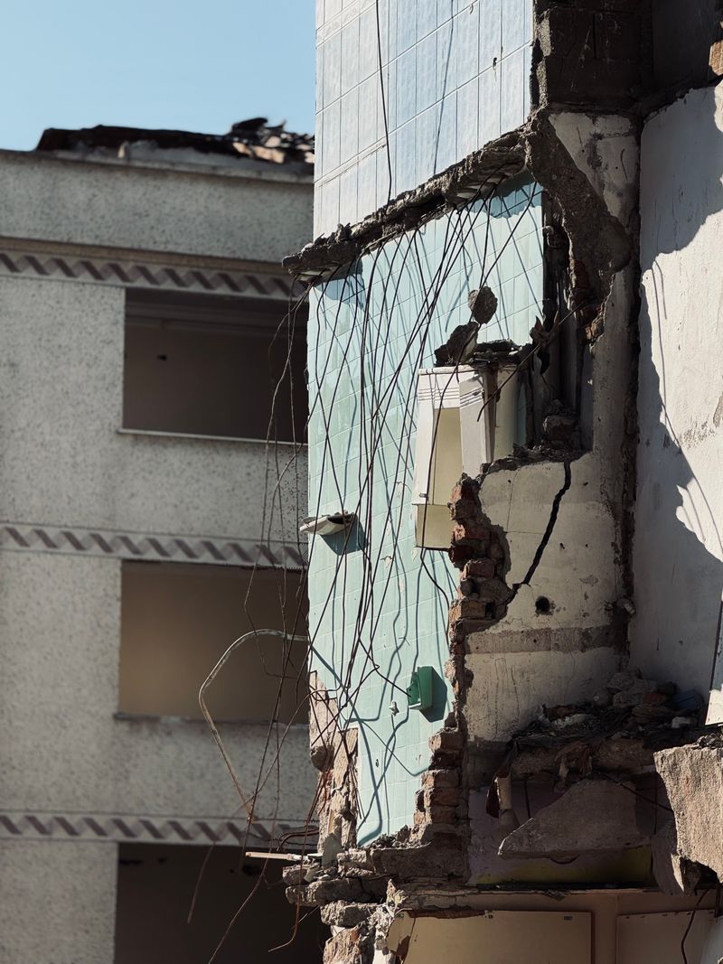 Partially demolished residential building with exposed exterior wall