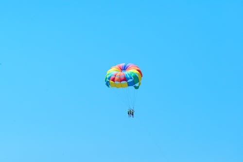People Flying in a Parachute