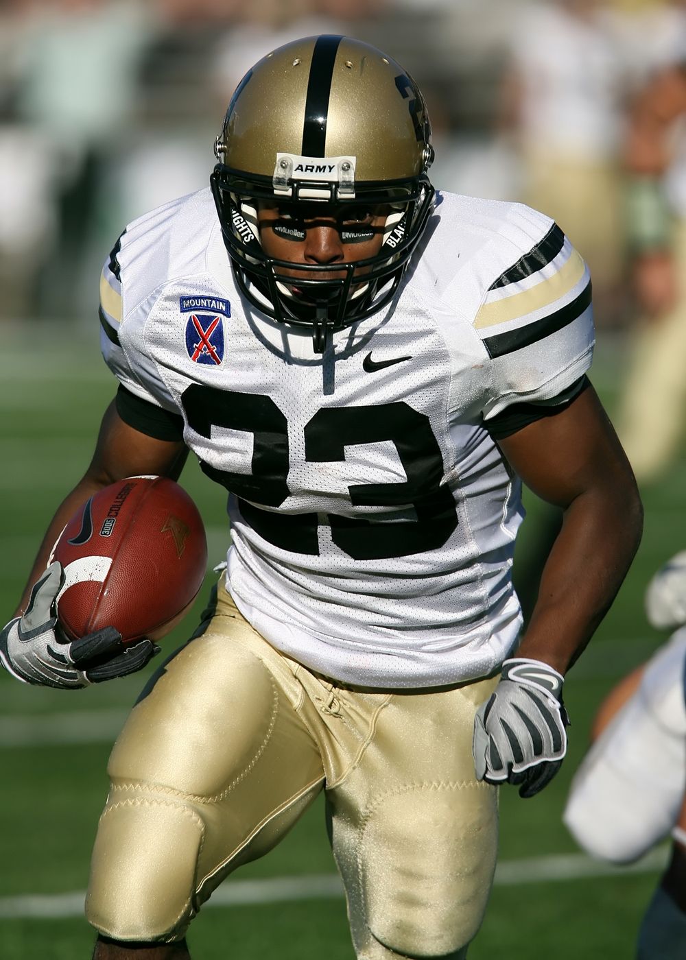 Football player rushing forward on the field